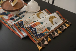 Detail of Middle East style table runner with moon stars and colorful tassels