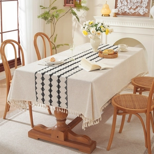 Minimalist beige cotton linen table runner with black geometric patterns and fringes