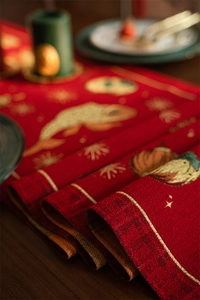 Close-up of red festive table runner with golden koi fish jacquard weaving texture