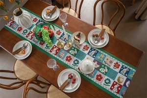 Close-up of Easter table runner with bunny and egg jacquard patterns on wooden surface