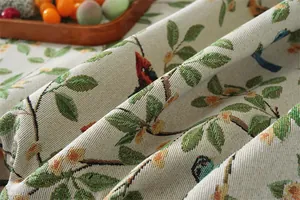 Close-up of thick jacquard fabric featuring retro floral and bird pattern with fringe