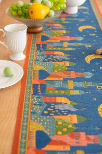 Detail of blue jacquard table runner with mosque architecture and golden moon patterns