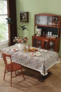 Detailed close-up of William Morris floral jacquard tablecloth with beige tassel edges