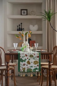 Close-up of Easter table runner with bunny jacquard patterns and green decorative tassels