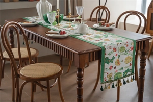 Close-up of Easter table runner with bunny, floral patterns and colorful tassels