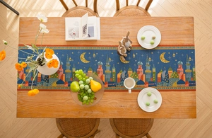 Detail of blue Middle Eastern table runner with golden moon, stars and castle patterns