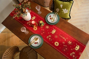 Close-up of festive red table runner with gold Chinese New Year patterns and tassels