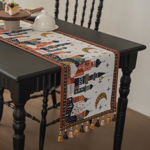 Exotic jacquard table runner with moon castle patterns and decorative colorful tassels