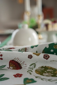 Macro detail of Easter jacquard table runner with golden threads and rabbit floral pattern