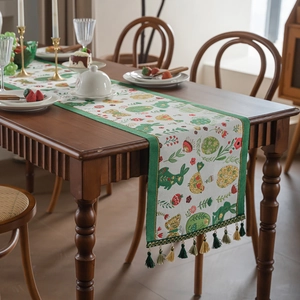 Easter table runner with woven jacquard bunnies, eggs and tassels on wooden table