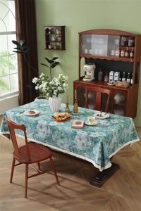 Detail shot of vintage jacquard tablecloth fabric with floral patterns and fringe