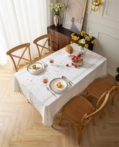 Detail of embroidered floral patterns and tassel edges on the rectangle tablecloth