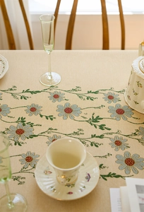Close-up of pastoral floral jacquard tablecloth with daisy pattern and fringe tassels