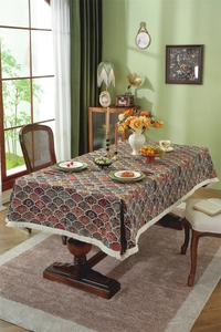 Close-up of bohemian jacquard tablecloth featuring colorful patterns and white tassels