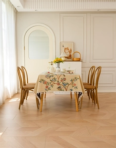Detailed view of floral jacquard tablecloth with elegant white tassel fringe edges