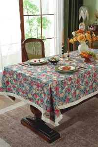 Close-up of vintage floral jacquard tablecloth with elegant white fringe details