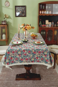 Detail of vintage floral jacquard tablecloth with elegant white fringe tassels