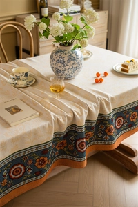 Detailed view of bohemian table cloth with jacquard floral borders and plant motifs
