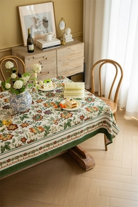 Detail of vintage floral jacquard tablecloth with elegant dark green contrast borders