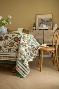 Detail of vintage jacquard tablecloth featuring red and green floral woven patterns