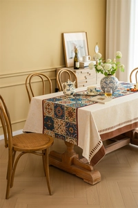 Detail of bohemian jacquard tablecloth with colorful geometric patterns and fringe edges