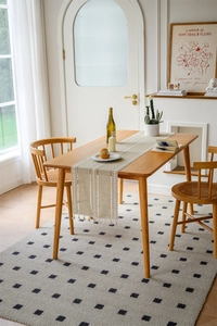 Detailed view of bohemian jacquard table runner with geometric patterns and handmade tassels