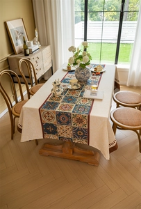 Detailed view of vintage ethnic jacquard tablecloth with floral patchwork and tassels