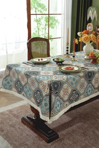 Detailed texture of jacquard fabric with bohemian patterns and white fringe tassels