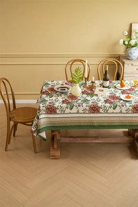 Close-up of vintage floral jacquard tablecloth with red roses and green stripe edge texture