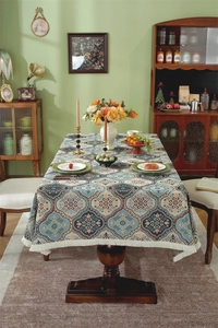 Macro view of boho jacquard tablecloth fabric featuring beige fringe and geometric patterns