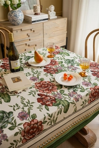 Macro view of vintage floral jacquard tablecloth with pink roses and green leaves