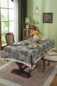 Detail of vintage jacquard tablecloth with colorful geometric patterns and white tassels