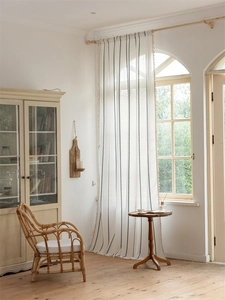 Close-up of bohemian jacquard curtain with blue geometric lines and decorative tassels