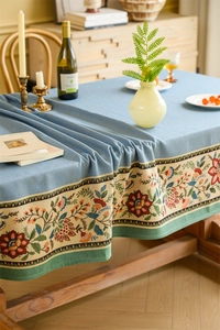 Detail of blue American vintage tablecloth with thick floral jacquard and ethnic embroidery