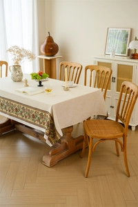 Detail of vintage floral jacquard tablecloth with intricate botanical borders and soft textures