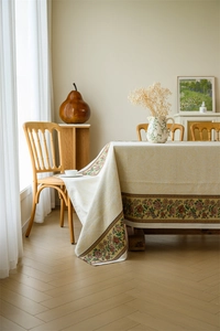 Detail of vintage floral jacquard tablecloth with elegant red and yellow flower borders