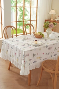 Close-up of floral print cotton tablecloth with elegant ruffled edges in a rustic style