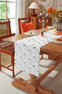 Detailed view of white Halloween table runner with 3D ghost pattern embroidery texture