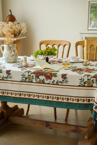 Close-up of vintage floral jacquard tablecloth with red roses and wide patterned edges