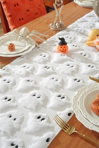 Close-up of white plush Halloween table runner with 3D ghost embroidery texture