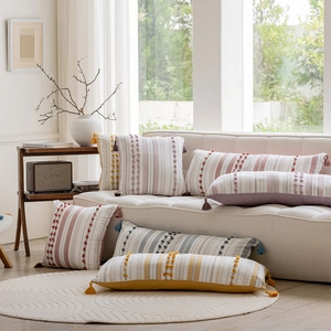Close-up of bohemian pillow cover showing textured fabric and tassel details