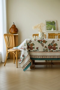 Detailed view of vintage floral jacquard tablecloth with thick knitted texture and leaf border