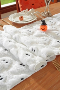 Detailed plush jacquard texture with cute white embroidered ghost patterns on festive runner