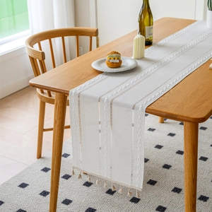 Bohemian jacquard table runner with white woven stripes and handmade tassels for dining decor