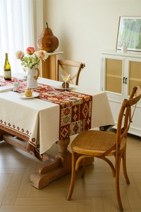 Close-up of retro bohemian jacquard tablecloth with ethnic geometric patterns in warm tones