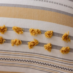 Detailed macro view of yellow tufted patterns and geometric weave on cotton pillowcase