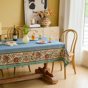 Blue rectangular vintage floral jacquard tablecloth with ethnic plant patterns on a dining table