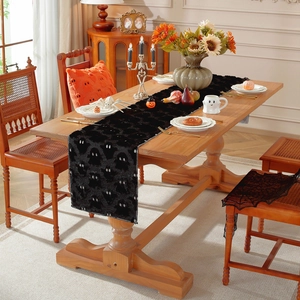 Halloween table runner featuring white ghost embroidery on black plush fabric for home decor