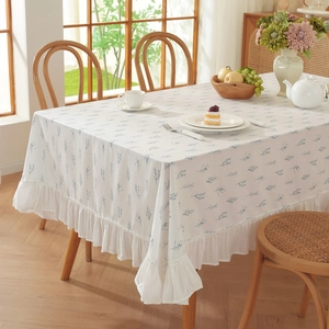 Floral print cotton tablecloth with elegant ruffled edges and blue leaf patterns