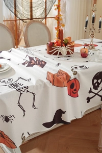 Detailed fabric texture of Halloween tablecloth with skull, pumpkin and bat patterns
